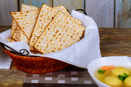 Delicious Matzoh ball soup with matzah, Jewish symbols for the Passover Pesach holiday