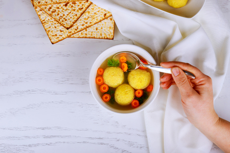 Homemade Matzo Ball Dumplings with Parsley for passover and Delicious Matzoh ball soup with crackers wine and dillの写真素材
