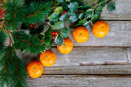 Tangerines, christmas tree branches wooden surface background with copy space. Christmas background.の写真素材