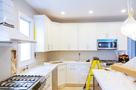 Installing new induction hob in modern improvement Kitchen Remodel Beautiful white kitchenの写真素材