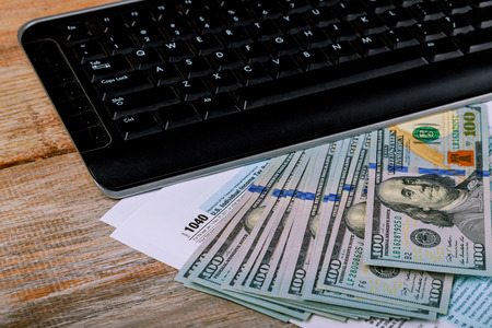 Filing online taxes before deadline 1040 U.S. Individual Income Tax Return and banknote, finance...