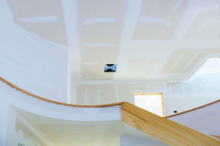 Newly constructed house interior room with unfinished view of gypsum wall with joints at building site.の写真素材