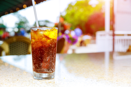 A glass containing an alcoholic drink on lemon and ice cold a table of a terrace of a bar of closeupの写真素材