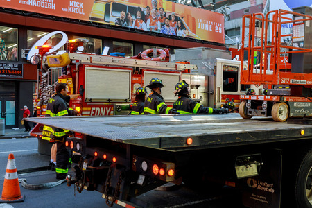 NEW YORK CITY - Jujy 02, 2018: Firefighters with the fire departments pump fuel from the car after...