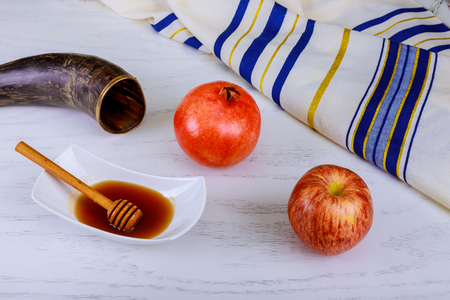 Honey, apple and pomegranate for traditional holiday symbols rosh hashanah jewesh holiday on wooden white background.の写真素材