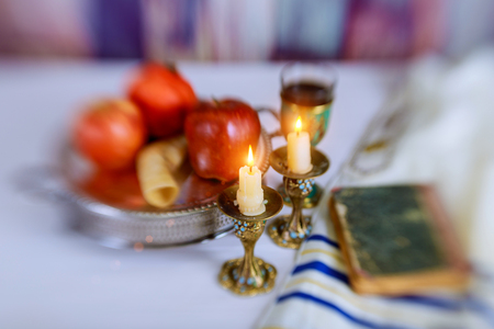 Jewesh holiday shofar, torah book, honey, apple and pomegranate rosh hashanah traditional holiday symbols. Selective soft focusの写真素材