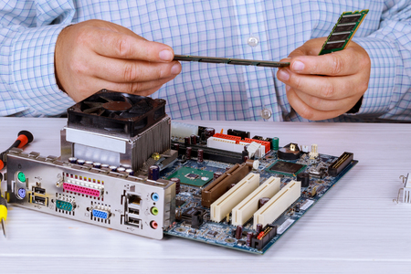 Installing random access memory into PC The concept of service electronics and computers.