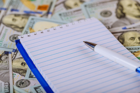 Top Of notebook and US Dollar Banknote Background, Use As Business Finance Concept.の写真素材