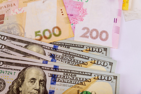 US dollars and ukrainian hryvnia, banknotes money set background.