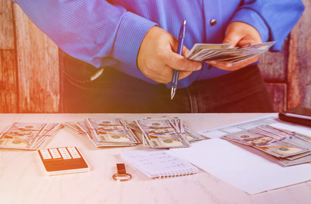 The man hand recount dollars. counts the money. new hundred dollar billsの写真素材