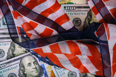 Top view american flag on us dollars of US paper currencyの写真素材
