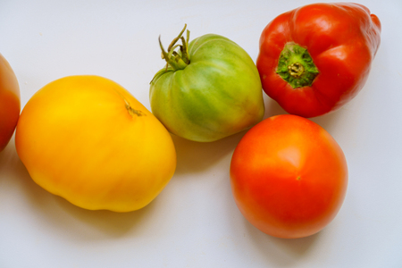 Collection of vegetables on bulgarian bell peppers and tomatoes with dew. multicolored tomatoes and peppersの写真素材