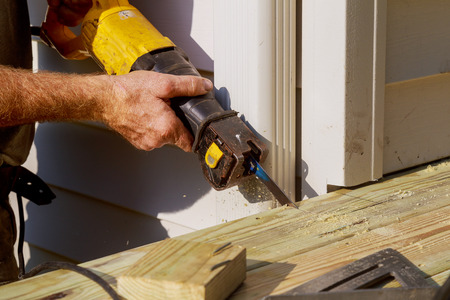 Detail of saw cutting piece of wood construction terrace and porchの写真素材