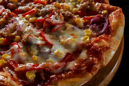 Pizza with corn, bacon, chili, onion parmesan cheese and chickenの写真素材
