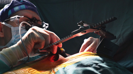 Surgeons working with a scissors on a patient in a operating theater