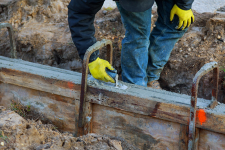 Construction workers leveling concrete pavement. Masonry construction workersの写真素材