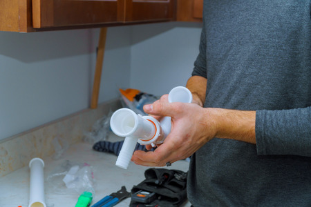 Hands plumber at work in a install a kitchen sink, plumbing repair service, assemble and installの写真素材