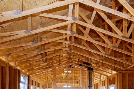 Framing structure wood frame of wooden houses home. Closeup new stick built home under construction...