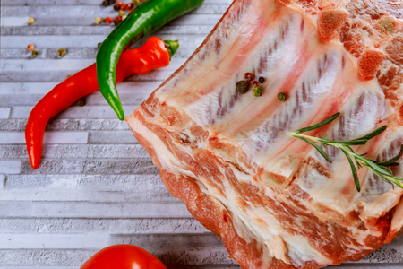 Raw pork steak ready for cooking with herbs. Gray cutting boards.の写真素材