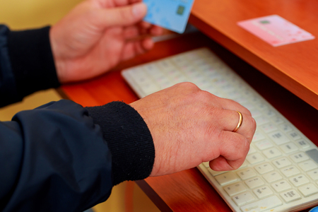 Hands holding plastic credit card and using tablet pc. Online shoppingの写真素材