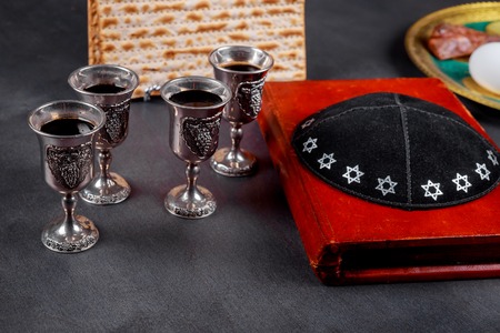 Matzot and red wine four glasses of symbols of Passoverの写真素材