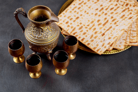 Pesah celebration concept Jewish Matzah bread with four glasses wine. Passover holiday concept