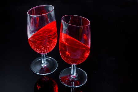 Red cold jelly in the glasses pieces with on the black backgroundの写真素材