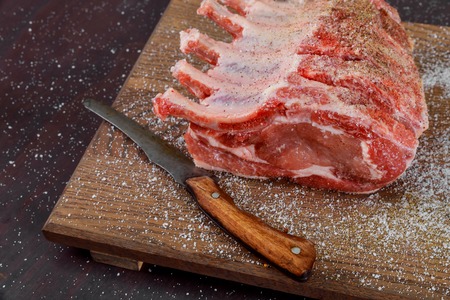 Fresh pork with ingredients for cooking on wood cutting boardの写真素材