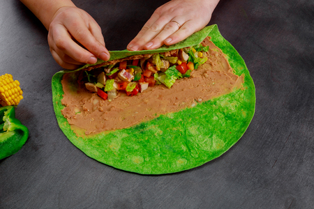 Mexican burito with sauce and pepper. Burito with side dish in restaurant.の写真素材