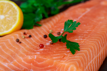 Fresh fish, salmon fillet with vegetables top view, tasty and healthy food of lemon and fresh leavesの写真素材
