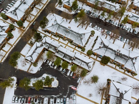 A beautiful winter day, a view of the panorama made with the drone, a sunny view of city street with housesの写真素材
