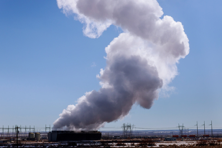 Industrial power plant station steaming cooling towers in blue sky.の写真素材