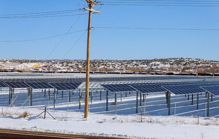 solar panels in winter view of snow covered solar panel park, photovoltaic power station on the...