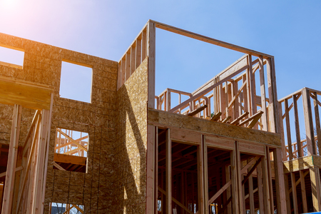 Residential construction home, wood beams with blue sky framed construction