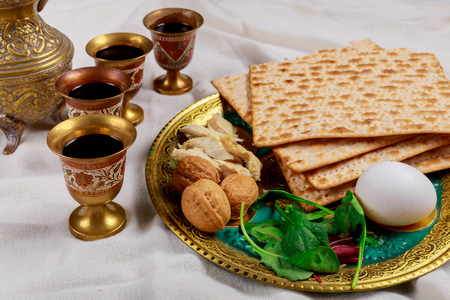 Passover matzoh jewish holiday bread over table background.