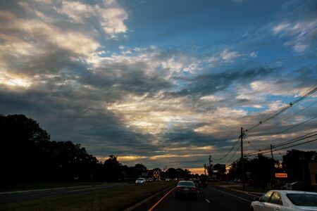 19 APRYL 2019 9 roads New Jersey USA Cars in traffic at anlights on a busy highway evening sunset