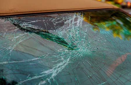 Broken front window car glass cracked for accident repair