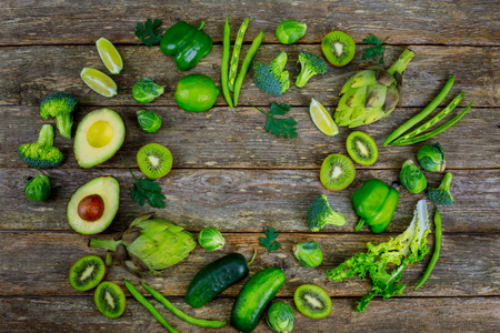Variety of green vegetables on the wood table broccoli and avocadoの写真素材
