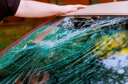 Glass broken cracks splinters in front of car front window.の写真素材