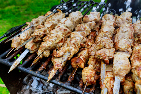 Barbecue skewers meat kebabs with grill kebabs cooking on a barbecueの写真素材