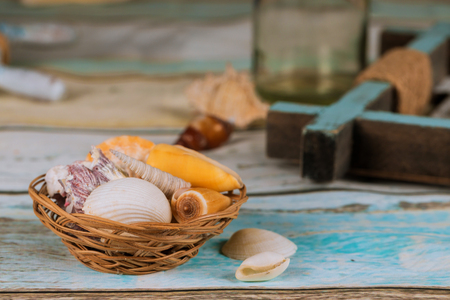 Summer vacation sea shells on blue plank background of rest summerの写真素材