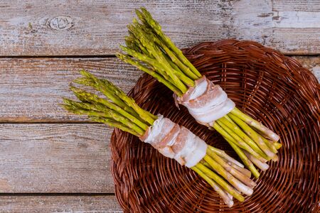 Green organic asparagus wrapped with rolled in baconの写真素材