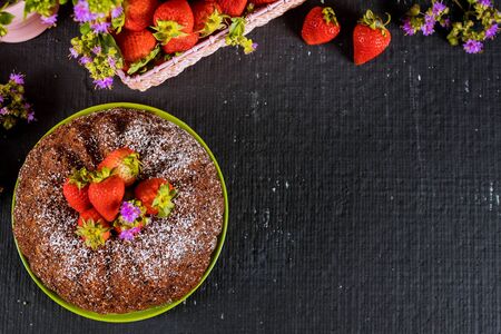 Banana bundt cake decorated with fresh strawberries .の写真素材