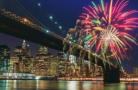 Colorful holiday fireworks panoramic view New York city Manhattan downtown skyline at night with...
