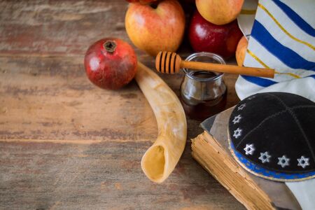 Honey and apples on shofar horn jewish holiday Rosh Hashanah torah book, kippah a yamolka talitの写真素材
