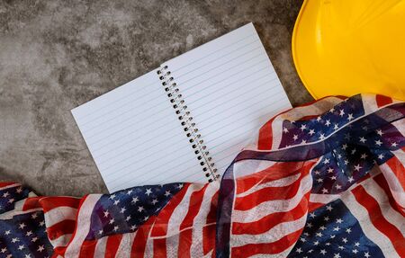 Labor day concept yellow helmet on USA national flag american patriotic