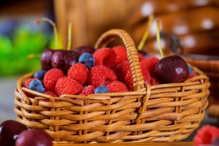 Assortment of fresh berries, blueberry, cherry, raspberry summer fresh berries in the basket healthy food selective focus.の写真素材