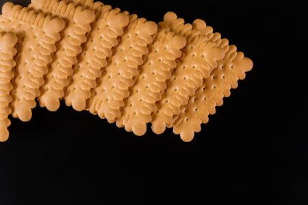 Square shape salty crackers on black background