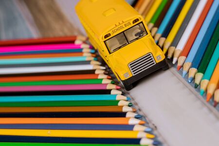 Toy yellow school bus toy with colored pencilsの写真素材