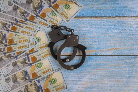 US dollar banknotes money cash corruption, dirty money financial crime and metal police handcuffsの写真素材